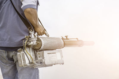 Midsection of man doing pest control 