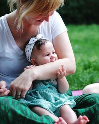 Close-up of daughter biting mother hand