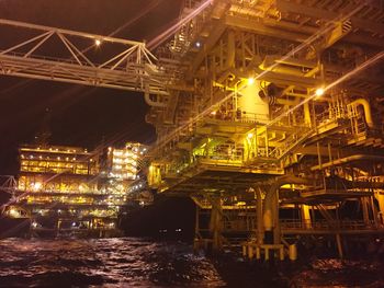 Low angle view of illuminated bridge at night