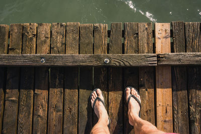 Low section of woman standing on wood