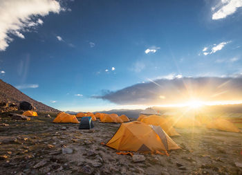 Scenic view of tent against sky during sunset