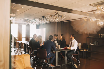 Male and female lawyers planning in meeting at office