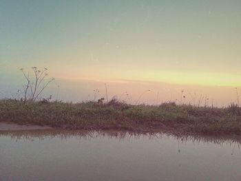 Scenic view of landscape against sky at sunset
