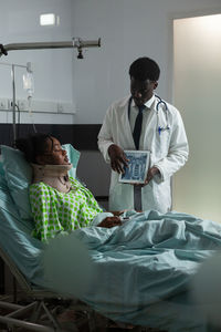 Full length of young woman lying on bed