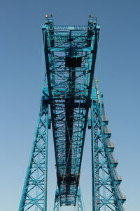 Low angle view of bridge against clear blue sky