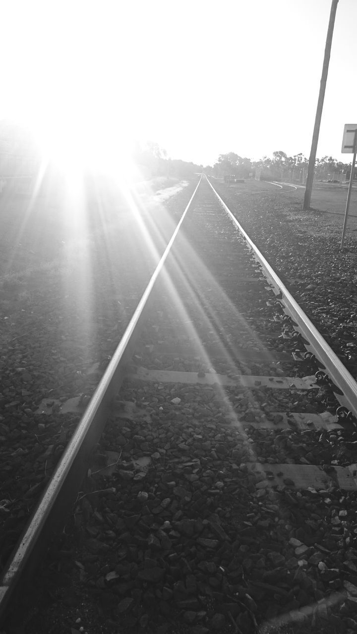 sun, sunbeam, lens flare, sunlight, clear sky, the way forward, sunny, diminishing perspective, bright, sky, vanishing point, transportation, railroad track, outdoors, nature, day, tranquility, no people, connection, landscape