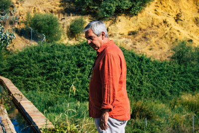 Side view of man standing on field