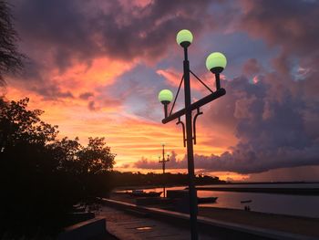 Street light against orange sky