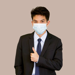 Portrait of man standing against white background
