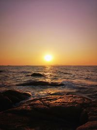 Scenic view of sea against clear sky during sunset