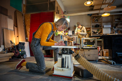 Rear view of man standing in factory