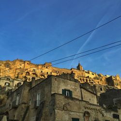 Low angle view of buildings against blue sky