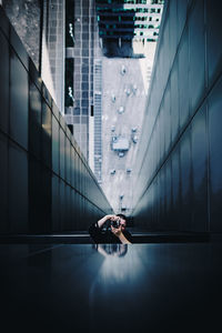 Reflection of woman photographing through camera on glass