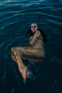 Low section of woman swimming in sea