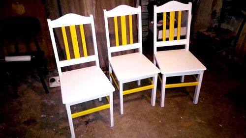 Close-up of chairs and table at home