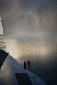 Man walking on tiled floor against sky