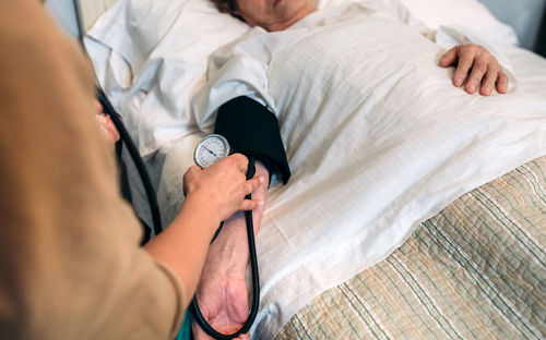 Midsection of doctor examining patient at hospital