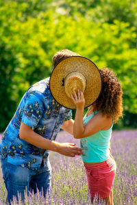 Full length of woman wearing hat while standing on field