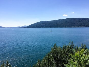 Scenic view of sea against blue sky