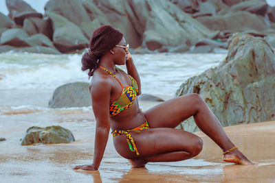 Africa ghana woman enjoying on a beach in axim ghana west africa with traditional african swimwear 