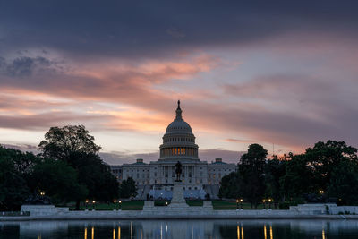 View of building against cloudy sky at sunset