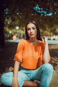 Portrait of young woman sitting outdoors