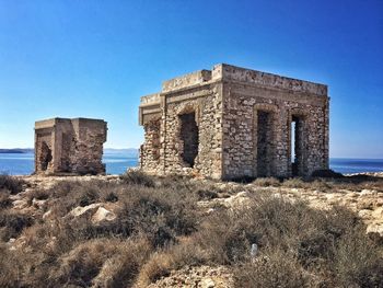 Ruins of building against blue sky