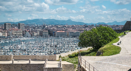 Distant view of vieux port in city against sky