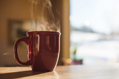 Close-up of coffee cup on table at home