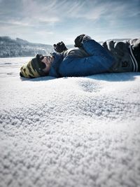 Surface level of people on snow against sky