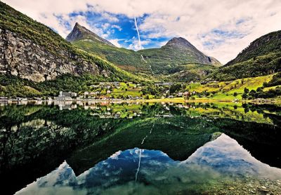 Scenic view of geiranger village with mountains against sky