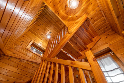 Bottom up view of wooden stair with railing in a country house. cozy atmosphere of country house