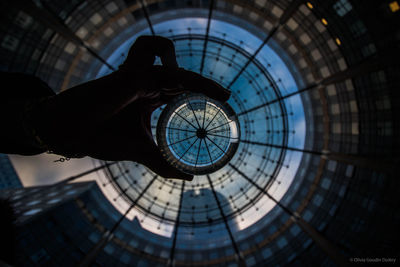 Person holding glass of building