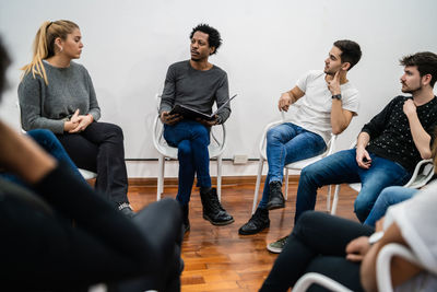 Colleagues discussing in meeting at office