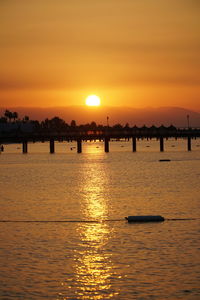 Scenic view of sea against orange sky