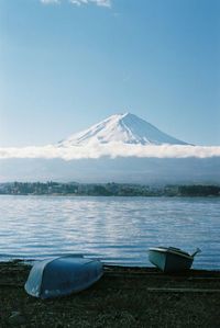 Scenic view of lake by mountains against sky