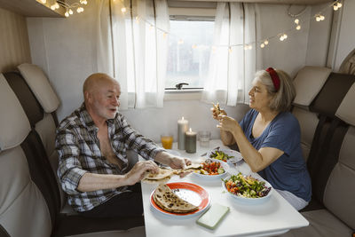 Senior couple eating lunch together in motor home