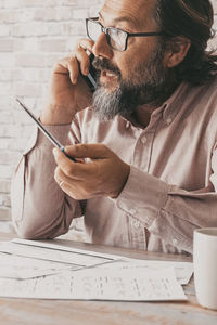 Side view of man working at table