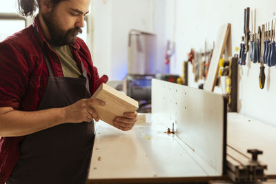 Young man working at workshop