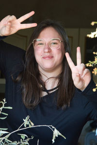 Portrait of smiling woman gesturing outdoors