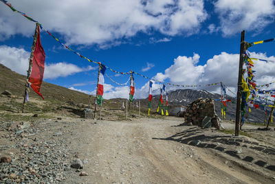 Clothes drying on field against sky