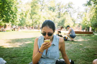 Rear view of woman standing in park