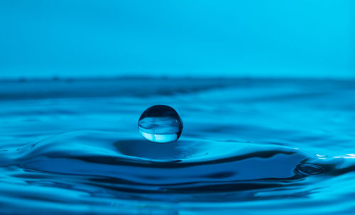 Close-up of splashing water against blue background