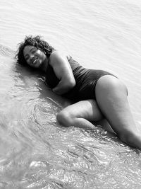 Portrait of young woman swimming in sea