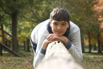 Portrait of young woman sitting on field