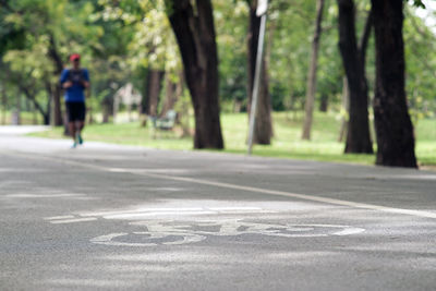 Man walking on road in city