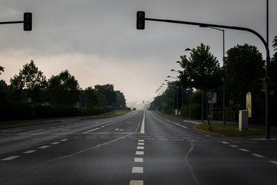 Empty road along trees