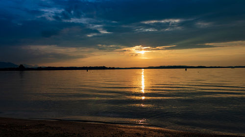 Scenic view of lake chiemsee against sky during sunset