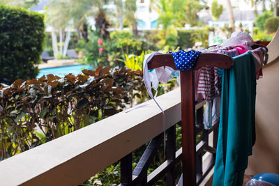 Swimwear and beach towels  driyer on the balcony near tropical garden and pool