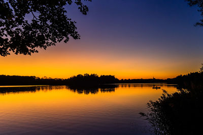 Scenic view of lake against orange sky